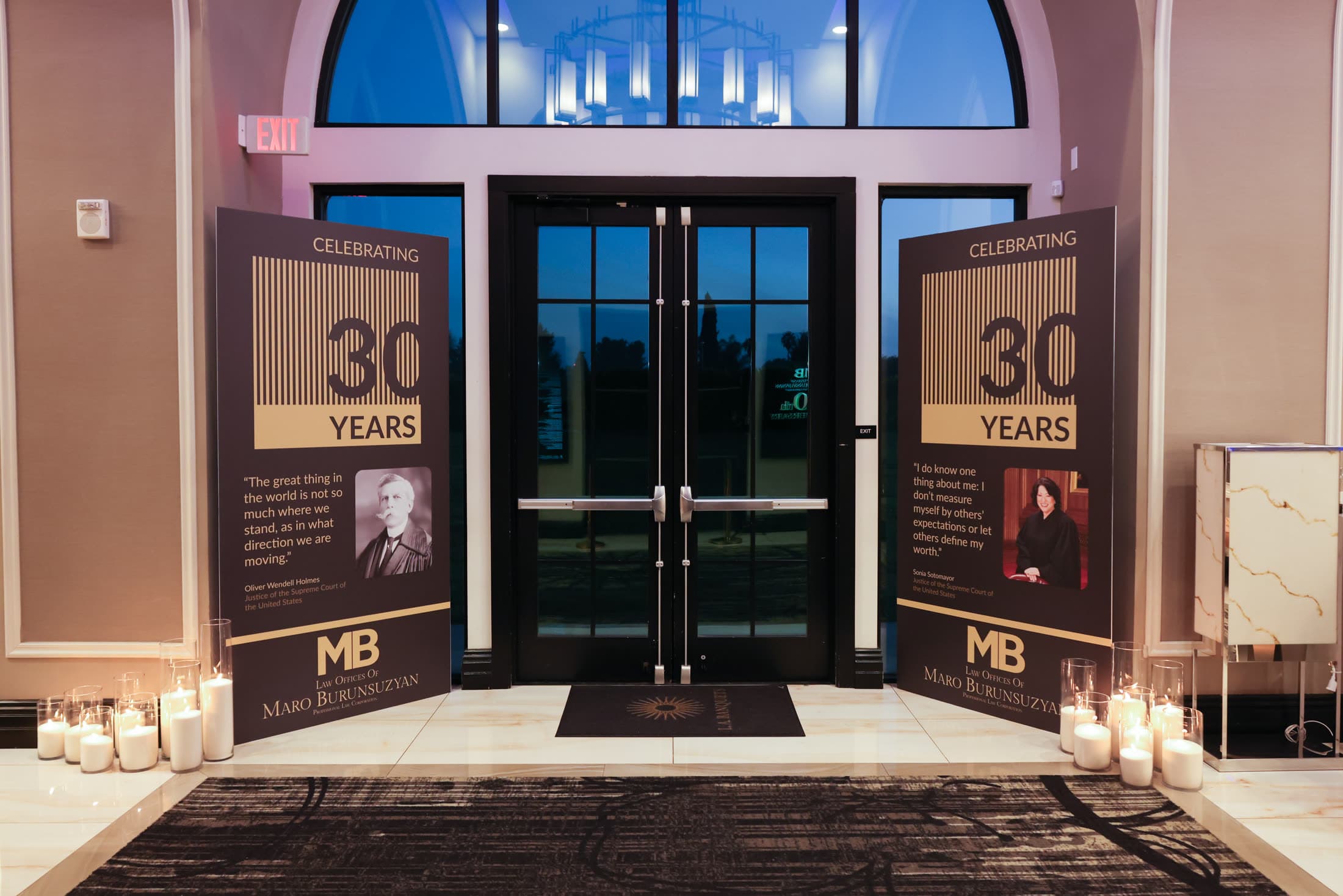 The candlelit entrance to the firm's celebration of three decades of practice
